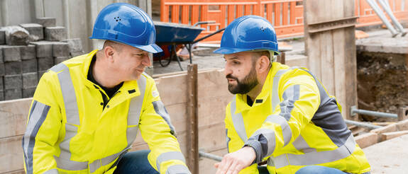 Zwei Fachleute der Stadtwerke Esslingen bei einer Besprechung auf einer Fernwärme-Baustelle in Esslingen.