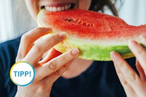 Frau beißt in ein Stück Melone