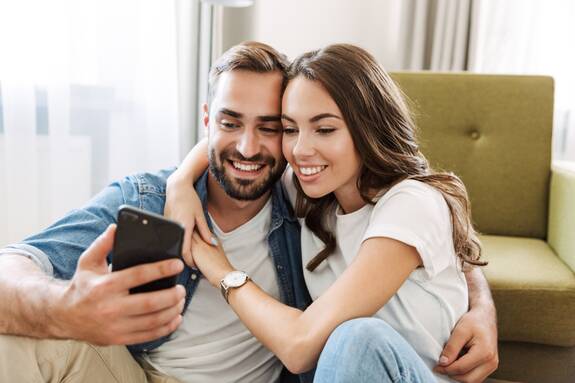 Mann und Frau schauen gemeinsam auf ein Handy